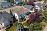 Discover this stunning multi-level home featuring a spacious deck with glass railings, perfect for outdoor entertaining.