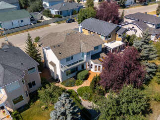 Discover this stunning multi-level home featuring a spacious deck with glass railings, perfect for outdoor entertaining.