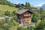 Nestled amidst lush greenery and offering breathtaking mountain views, this charming chalet boasts traditional alpine architecture with modern comforts.