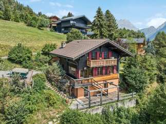 Nestled amidst lush greenery and offering breathtaking mountain views, this charming chalet boasts traditional alpine architecture with modern comforts.