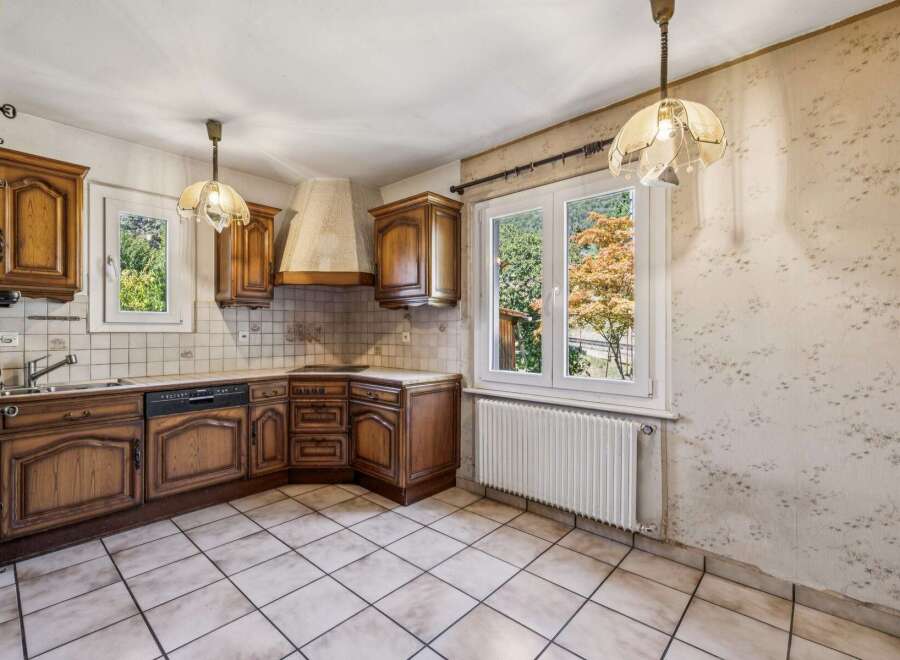 Discover this charming kitchen featuring classic wooden cabinetry and a functional layout.