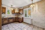 Discover this charming kitchen featuring classic wooden cabinetry and a functional layout.