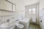 This classic bathroom features a functional layout with a bathtub, sink, and toilet.