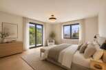 Experience breathtaking mountain views from this serene bedroom, featuring a spacious king-size bed adorned with plush pillows and a cozy throw.