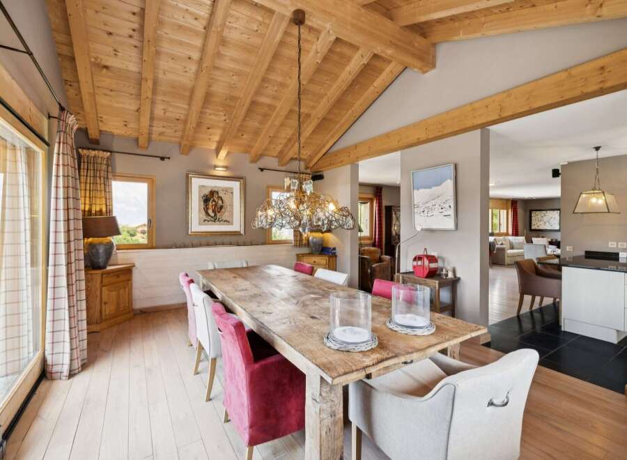 Experience rustic elegance in this spacious dining room, featuring a grand wooden table perfect for gatherings.
