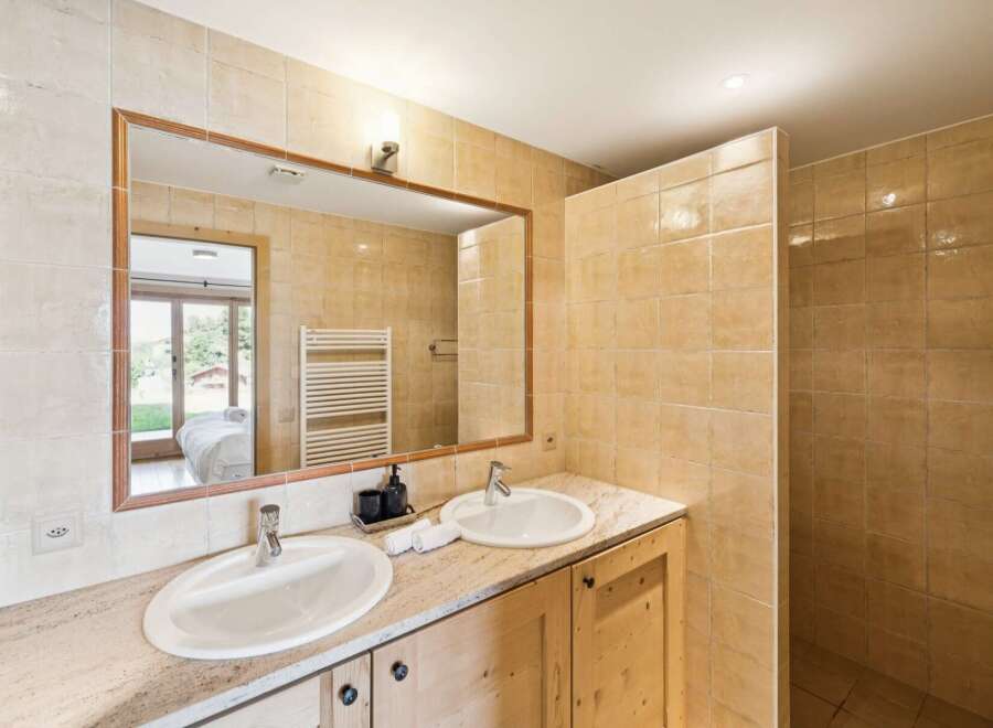 This luxurious bathroom features a spacious double vanity with granite countertops and two undermount sinks, perfect for busy mornings.