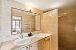 This luxurious bathroom features a spacious double vanity with granite countertops and two undermount sinks, perfect for busy mornings.