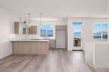 Experience modern living in this spacious open-concept kitchen and living area, featuring sleek cabinetry and a large island perfect for entertaining.