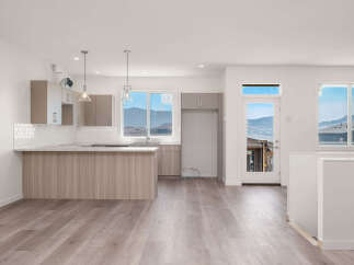 Experience modern living in this spacious open-concept kitchen and living area, featuring sleek cabinetry and a large island perfect for entertaining.