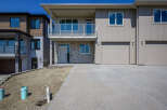 Discover modern living in this stunning townhouse featuring a sleek facade with stone accents and a spacious balcony.