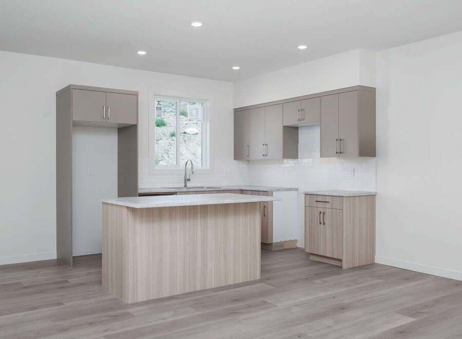 Discover this modern kitchen featuring sleek, dual-toned cabinetry and a spacious island perfect for meal prep and casual dining.