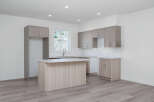 Discover this modern kitchen featuring sleek, dual-toned cabinetry and a spacious island perfect for meal prep and casual dining.
