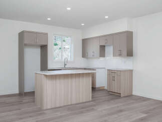 Discover this modern kitchen featuring sleek, dual-toned cabinetry and a spacious island perfect for meal prep and casual dining.