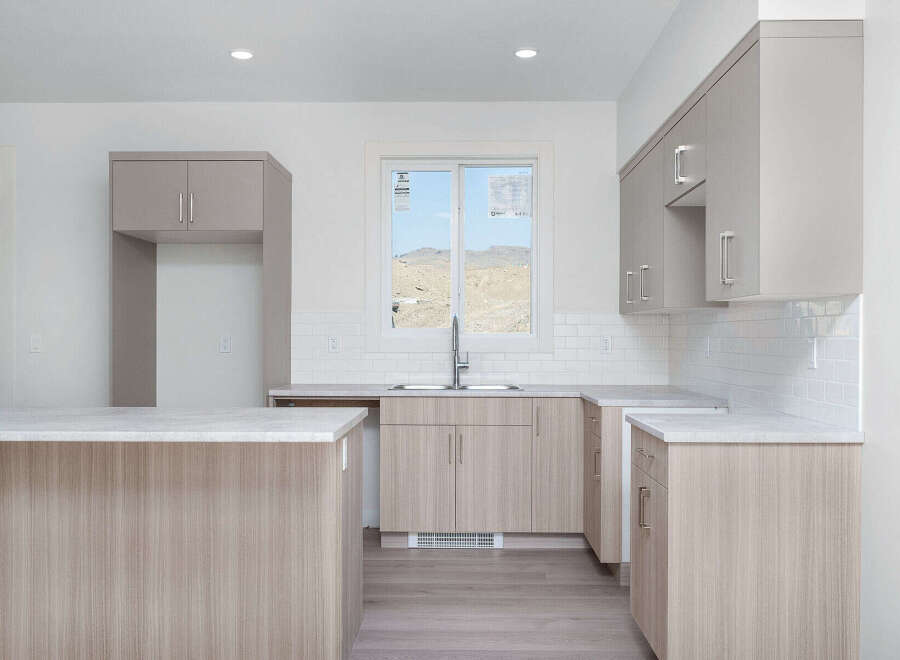 Discover this modern kitchen featuring sleek, light wood cabinetry and a spacious island perfect for meal prep and casual dining.