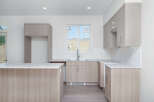Discover this modern kitchen featuring sleek, light wood cabinetry and a spacious island perfect for meal prep and casual dining.