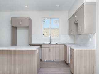Discover this modern kitchen featuring sleek, light wood cabinetry and a spacious island perfect for meal prep and casual dining.