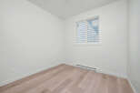 Discover modern living in this bright and airy room, featuring a large window that floods the space with natural light.