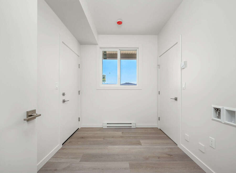 Step into this bright and airy hallway, featuring a clean white aesthetic and modern finishes.