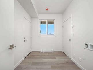 Step into this bright and airy hallway, featuring a clean white aesthetic and modern finishes.