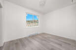 Discover this bright and airy bedroom, featuring a large window that floods the space with natural light.
