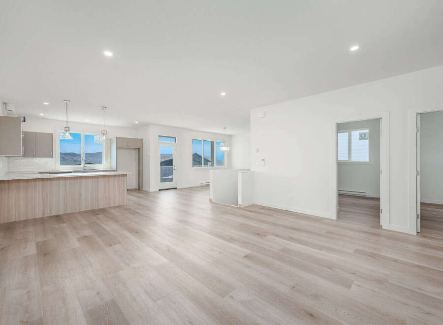 Experience modern living in this spacious open-concept home, featuring a sleek kitchen with a large island and ample natural light.