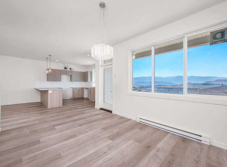 Experience modern living in this bright and airy open-concept space, featuring a sleek kitchen with ample cabinetry and a central island perfect for casual dining.