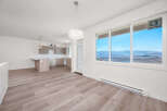 Experience modern living in this bright and airy open-concept space, featuring a sleek kitchen with ample cabinetry and a central island perfect for casual dining.
