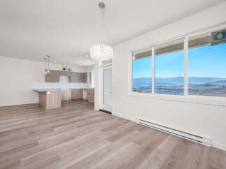 Experience modern living in this bright and airy open-concept space, featuring a sleek kitchen with ample cabinetry and a central island perfect for casual dining.
