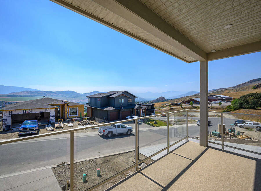 Enjoy breathtaking panoramic views from this stunning property, featuring a modern home under construction with a spacious balcony.