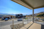 Enjoy breathtaking panoramic views from this stunning property, featuring a modern home under construction with a spacious balcony.