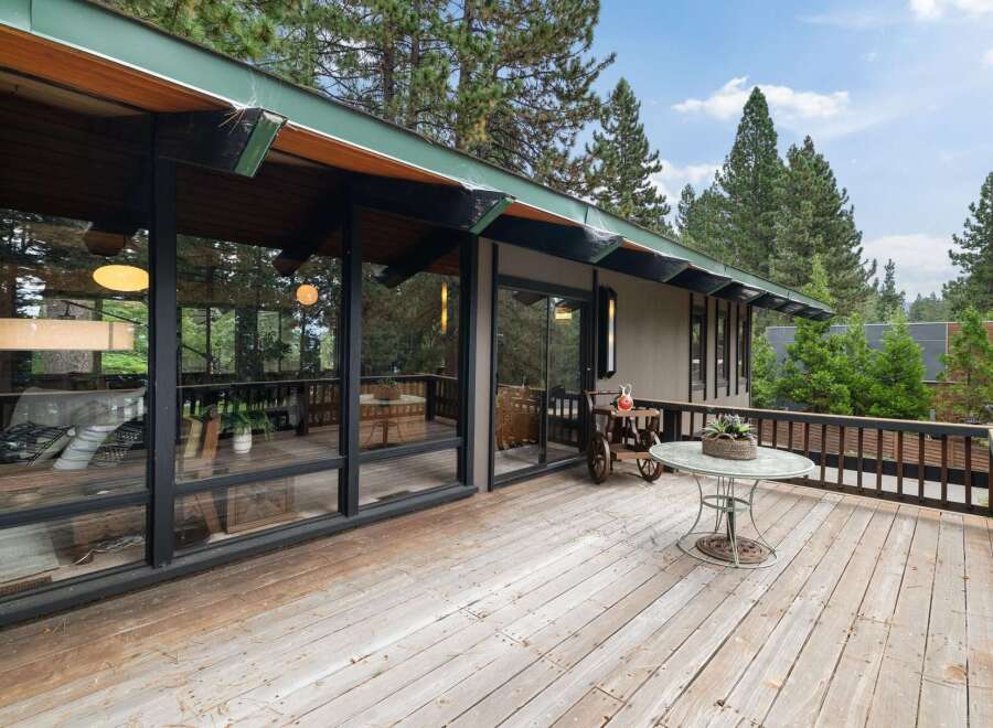 Enjoy the serene mountain lifestyle from this expansive wooden deck, perfect for outdoor living and entertaining.