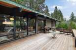 Enjoy the serene mountain lifestyle from this expansive wooden deck, perfect for outdoor living and entertaining.