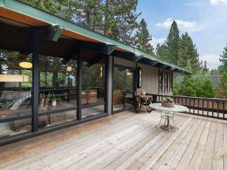 Enjoy the serene mountain lifestyle from this expansive wooden deck, perfect for outdoor living and entertaining.