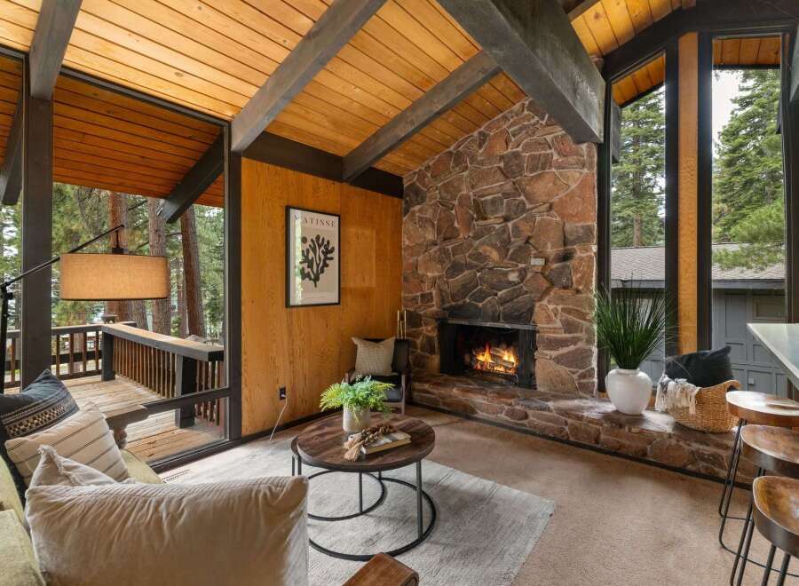 Experience rustic charm in this inviting living room, featuring a magnificent stone fireplace as the centerpiece.