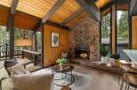 Experience rustic charm in this inviting living room, featuring a magnificent stone fireplace as the centerpiece.