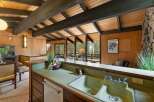 Experience the charm of this unique home featuring exposed wooden beams and a vaulted ceiling that creates an airy, open atmosphere.