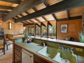 Experience the charm of this unique home featuring exposed wooden beams and a vaulted ceiling that creates an airy, open atmosphere.