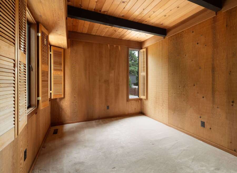 Step into this charming room featuring warm, natural wood paneling throughout, creating a cozy and inviting atmosphere.