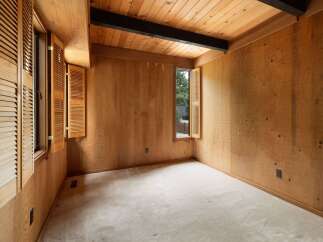 Step into this charming room featuring warm, natural wood paneling throughout, creating a cozy and inviting atmosphere.