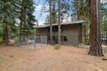 Discover this charming property nestled among tall pine trees, offering a private fenced yard perfect for pets or outdoor activities.