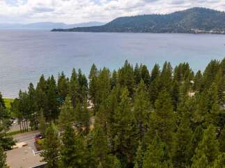 Experience the ultimate lakeside living with this stunning property offering breathtaking views of the expansive blue water.