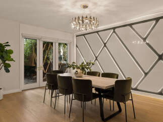 Experience elegant dining in this modern space, featuring a sleek wooden table surrounded by plush, dark green chairs.