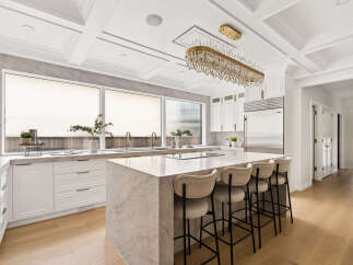 Experience luxury in this stunning kitchen featuring a grand marble island perfect for entertaining.