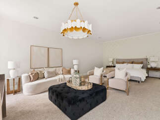 Experience luxury living in this stunning studio apartment, featuring a plush sectional sofa and two elegant armchairs perfect for relaxation.