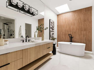 Experience modern luxury in this stunning bathroom, featuring a sleek floating vanity with ample storage and a freestanding soaking tub.