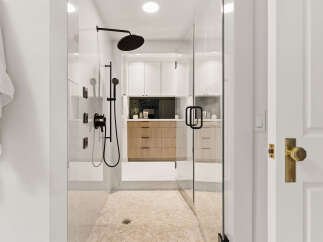 Experience luxury in this modern bathroom featuring a spacious glass-enclosed shower with a sleek black rain showerhead and multiple body jets.