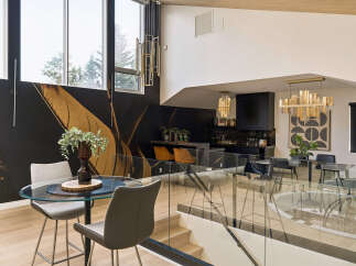 Experience modern luxury in this stunning home featuring a dramatic black and gold accent wall that creates a striking visual statement.