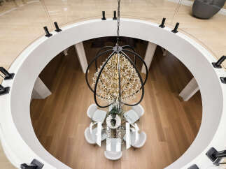 Experience luxury living in this stunning home featuring a grand circular foyer with a dramatic crystal chandelier.