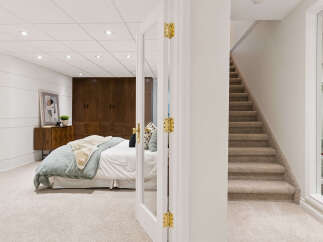 Discover this beautifully appointed bedroom featuring a plush carpet, a stylish wooden dresser, and ample storage with built-in dark wood closets.