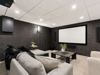 Experience cinematic bliss in this dedicated home theater, featuring a large projection screen and surround sound system.